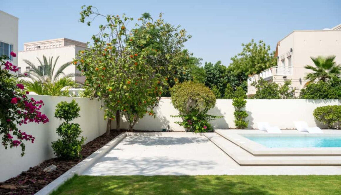 Residential landscape featuring green planting and a finished garden setting